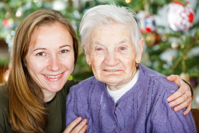 lady posing beside elderly woman