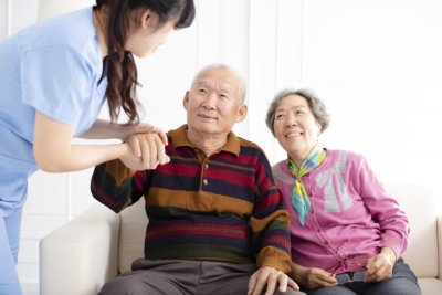 elderly couple with caregiver